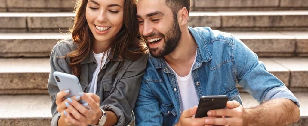 Lån utan säkerhet 4 Kvinna och man jämför möjligheten att låna pengar utan säkerhet på mobilen.